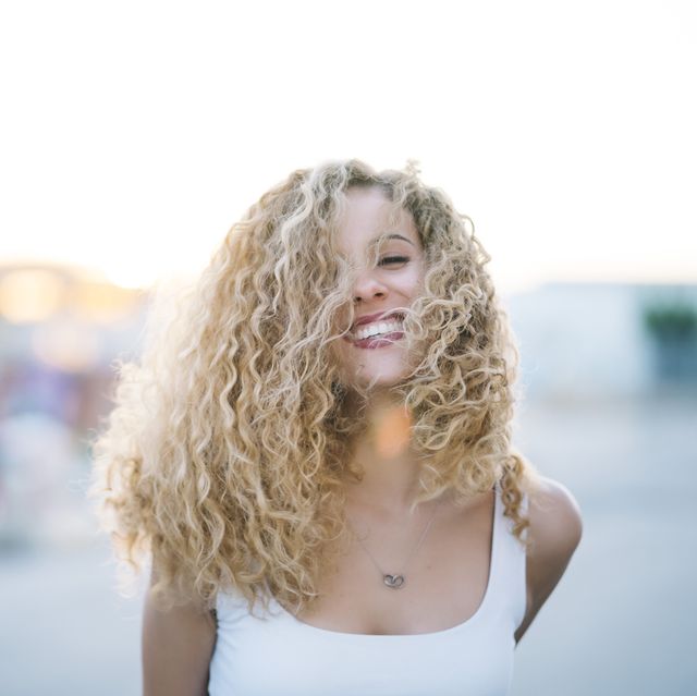 portrait of happy young woman with blond ringlets