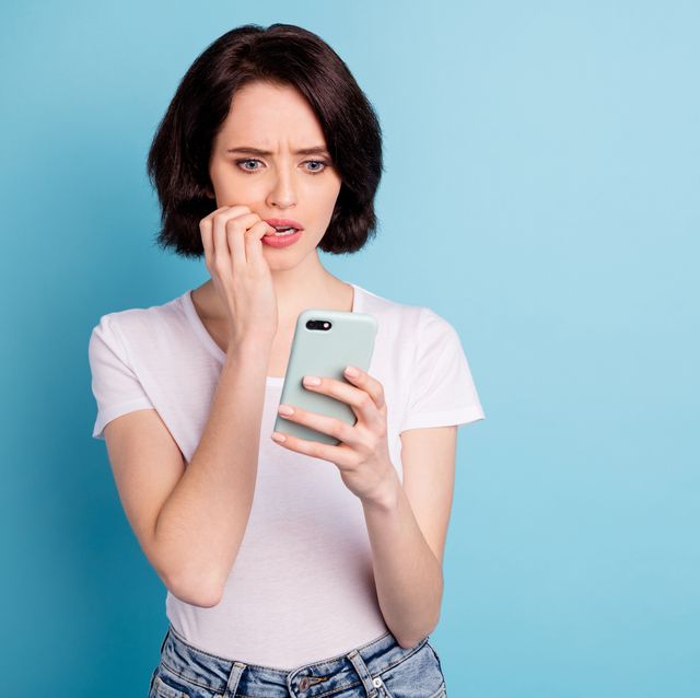portrait of her she nice attractive worried nervous girl using app 5g internet online media followers subscribe dislike isolated on bright vivid shine vibrant blue turquoise color background