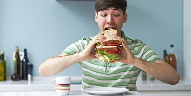 portrait of man eating giant sandwich