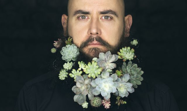 portrait of man with flowers in beard