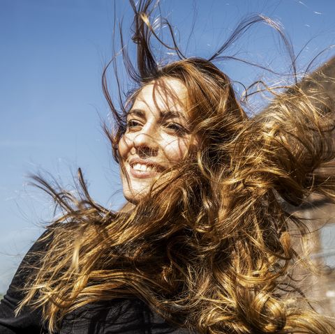 Portrait of smiling woman with blowing hair
