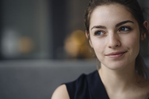 portrait of smiling young woman looking at distance