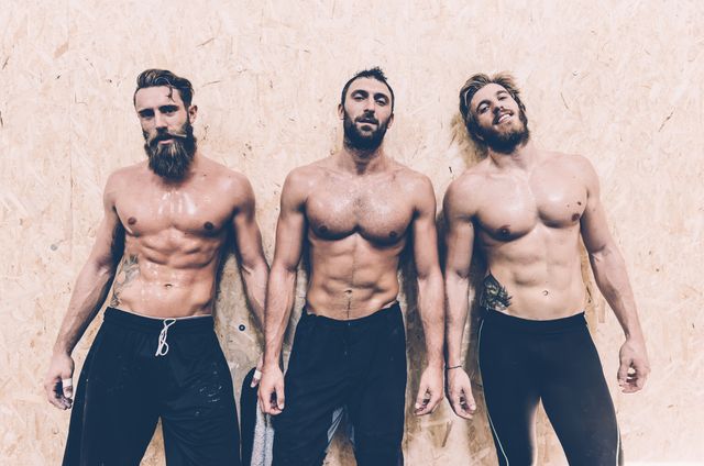 portrait of three macho male cross trainers in gym