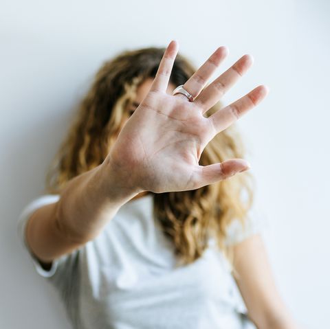 Portrait of Woman covering her face with her hand