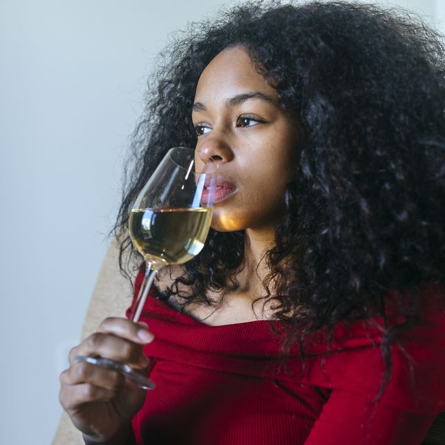 portrait of woman drinking glass of white wine