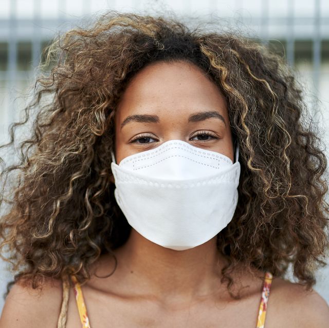 portrait of young woman with antiviral mask outdoors