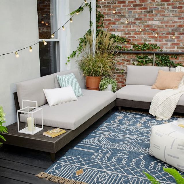 outdoor patio with sectionals and blue rug