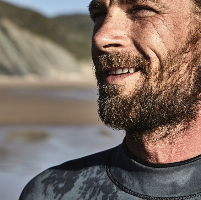 Portugal, Algarve, portrait of confident surfer on the beach