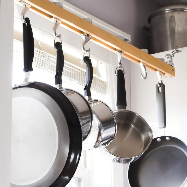 pans and pots hanging above kitchen sink