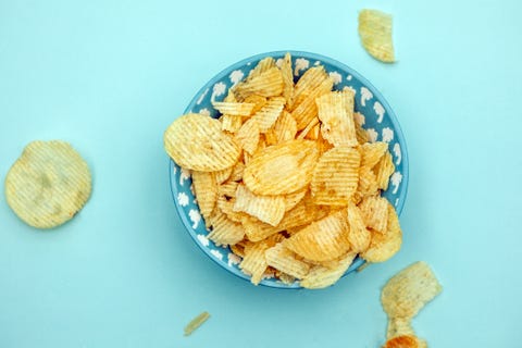 potato chips top view on turqoise background