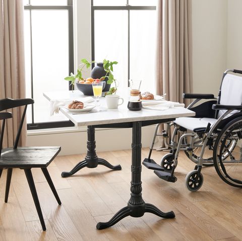 small rectangular table with one chair and a wheelchair