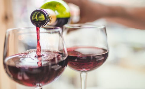Pouring red wine in glasses Pouring red wine in glasses