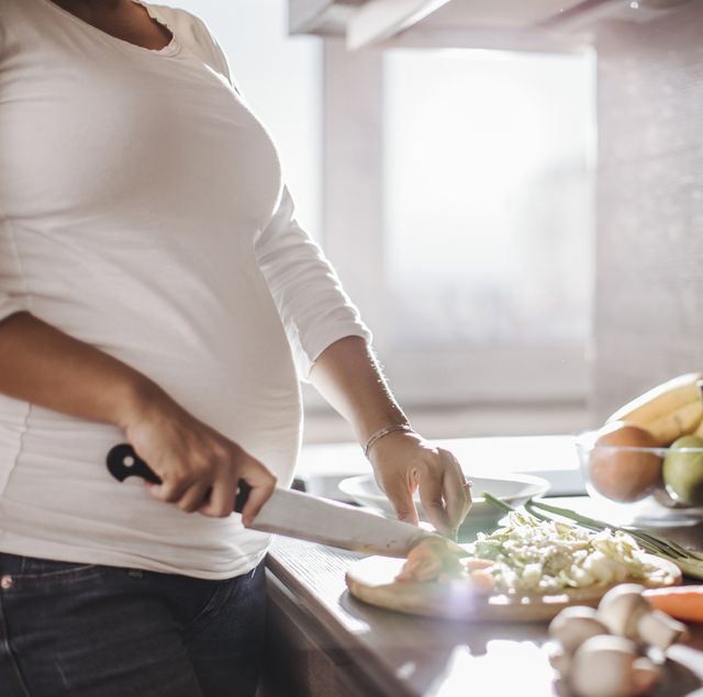 pregnant woman making a meal