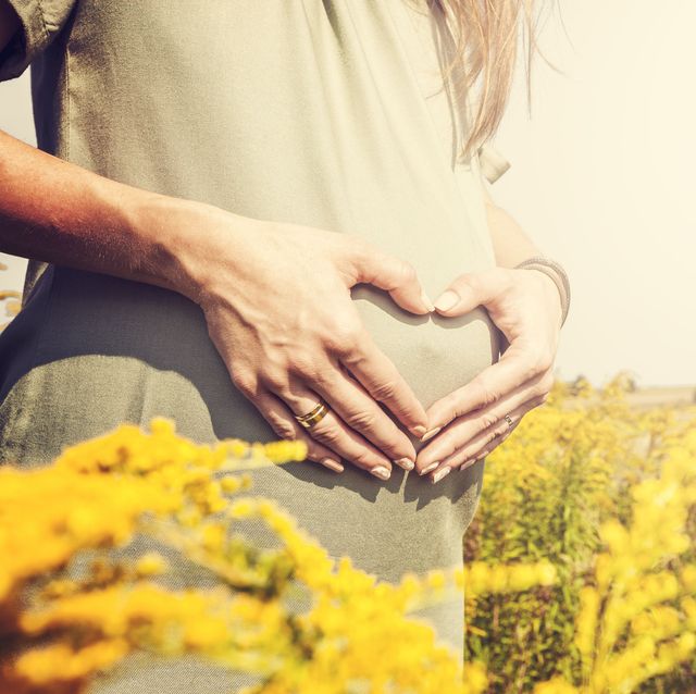 Pregnant woman relaxed in the field
