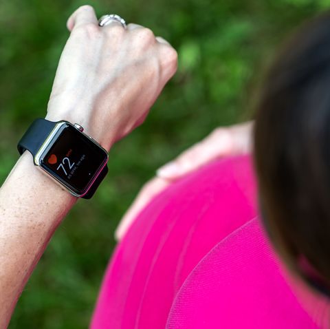 pregnant woman taking pulse on apple watch