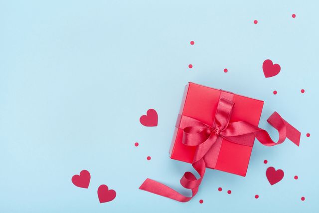 present or gift box, paper heart and confetti on blue background top view valentines day greeting card last minute valentines day gifts