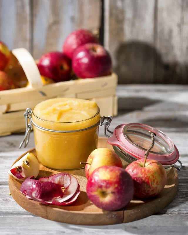 preserving jar of homemade applesauce and apples