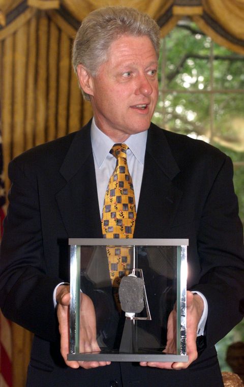 us president bill clinton holds a moon rock presen