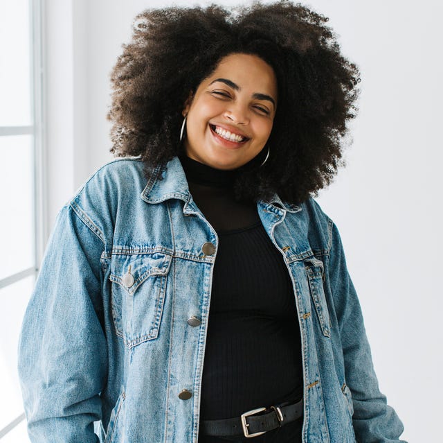 pretty woman with curly hair in fashionable wear