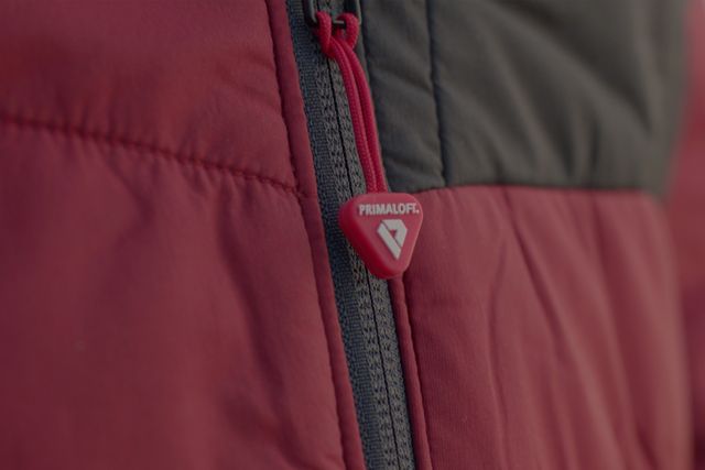 a red jacket with a primaloft zipper