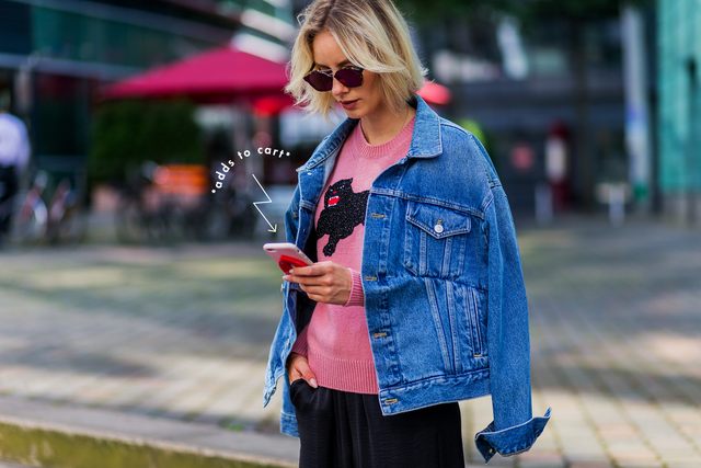 duesseldorf, germany   august 25  fashion blogger lisa hahnbueck lisarvd writing a text message on her phone wearing dior abstract sunglasses, blue denim balenciaga jeans jacket, a pink gucci wool knit with cat, black vince silk pants on august 25, 2016 in duesseldorf, germany photo by christian vieriggetty images