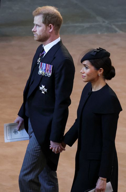 Meghan Markle and Harry hold hands at the funeral of Queen Elizabeth II