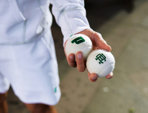 person holding tennis balls