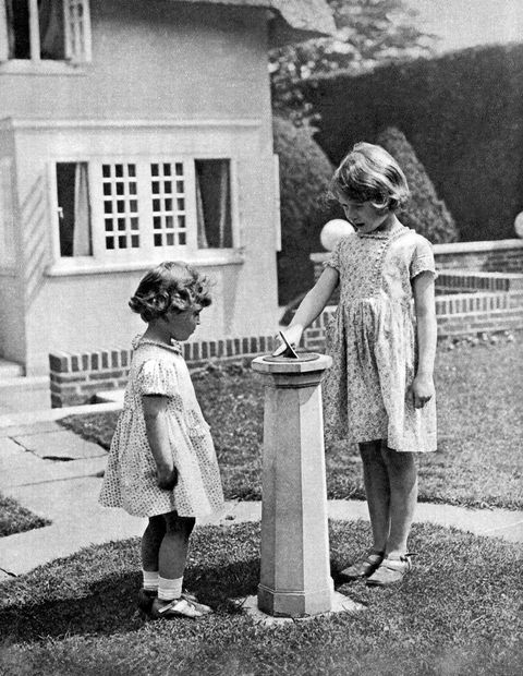 princess elizabeth, to become queen elizabeth ii, and princess margaret as children in the 'grounds' of the model house