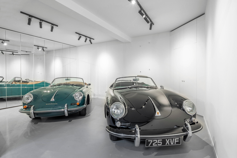 white garage with two classic cars