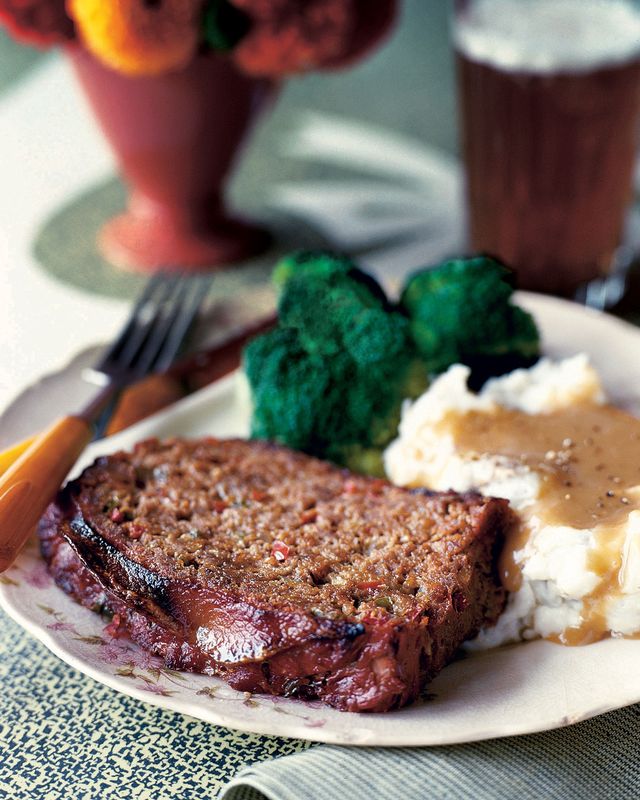 a slice of prized family meat loaf on a plate with mashed potatoes and broccoli