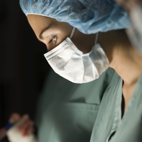 profile of a female surgeon operating
