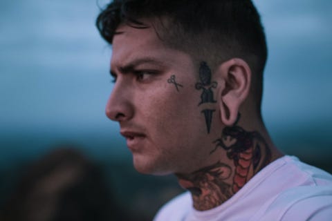 Profile View Of Man With Tattoo Looking Away profile view of man with tattoo looking away