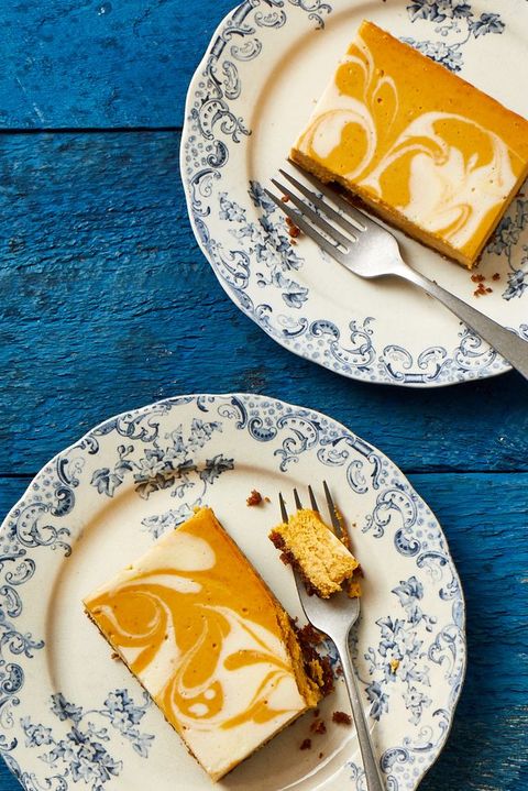 pumpkin swirled cheesecake bar on a blue decorative plate
