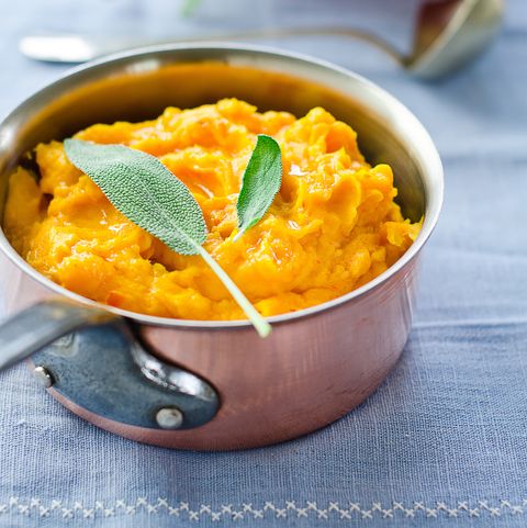 a copper pot of pumpkin puree on a blue tablecloth, a good housekeeping pick for a healthy weight loss food