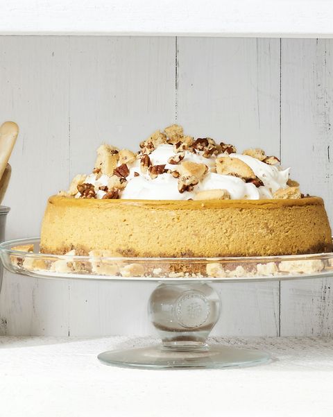 pumpkin cheesecake with cookie crust on a cake plate