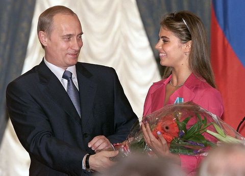 russian president vladimir putin l hands flowers to alina kabayeva, russian rhytmic gymnastics star and olympic prize winner, after awarding her with an order of friendship during annual award ceremony in the kremlin 08 june 2001   afp photo     epa poolsergei chirikov        photo credit should read sergei chirikovafp via getty images