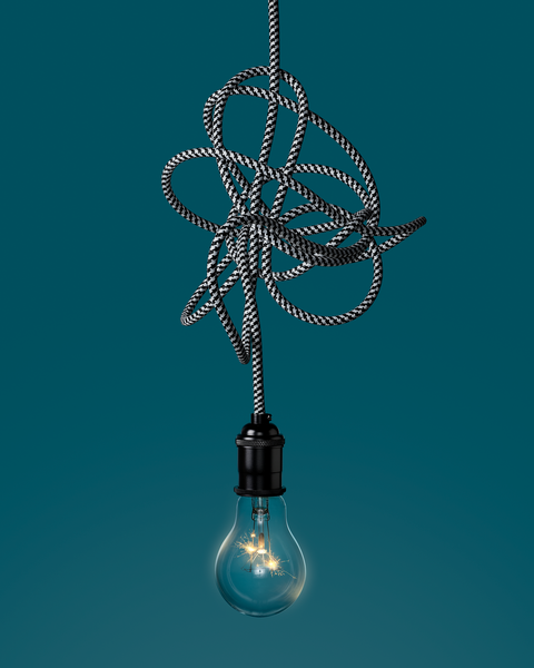 light bulb hanging from tangled wire light bulb hanging from tangled wire