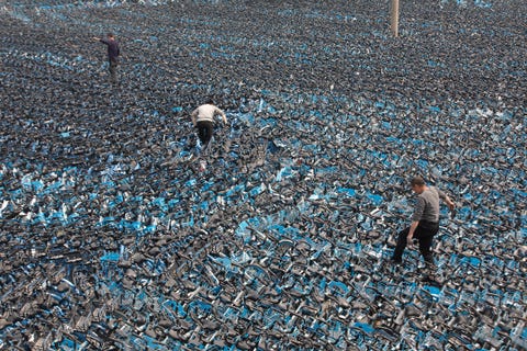 zhengzhou, china   april 08 employees of shanghai based bike sharing company hello global look for usable shared bikes piled up at a recycling depot on april 8, 2021 in zhengzhou, henan province of china photo by he zhiquanvcg via getty images