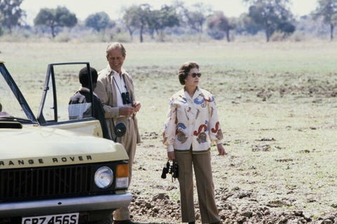 queen elizabeth ii, holding binoculars and wearing sunglasses, and prince philip, on safari in zambia