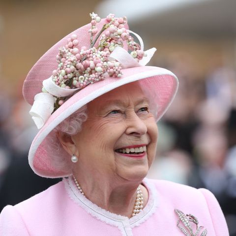 the queen hosts garden party at buckingham palace wearing a pink hat and pearls