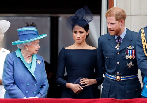 queen elizabeth, meghan markle, and prince harry chat on the buckingham palace balcony