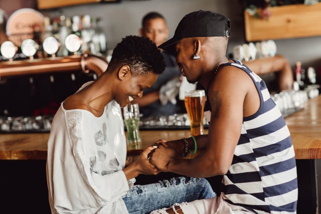 first date questions couple holding hands at a bar