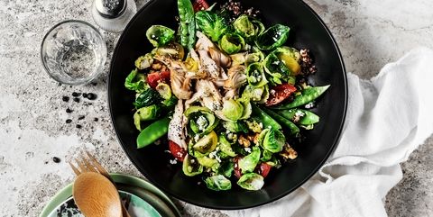 Fresh salad with chicken breast on gray, stone background