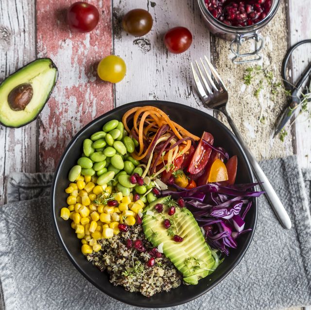 Quinoa veggie bowl of avocado, Edamame, tomatoes, corn, carrots, red cabbage and pomegranate seed
