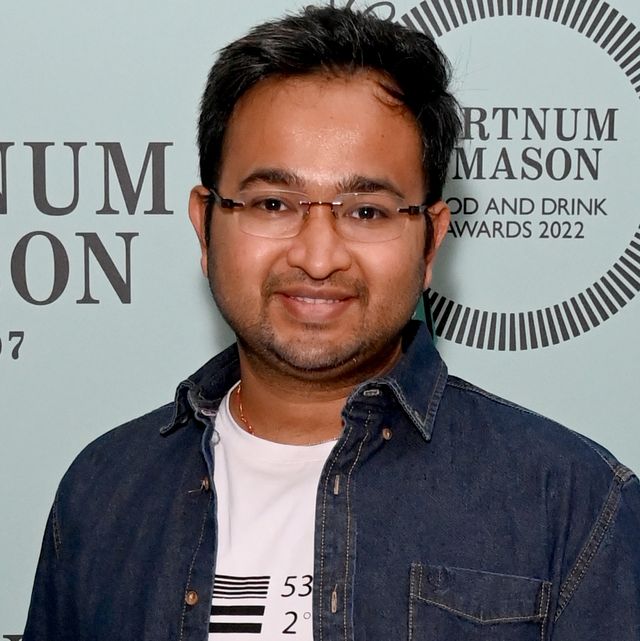 rahul mandal, former great british bake off champion, smiles as he attends a red carpet event