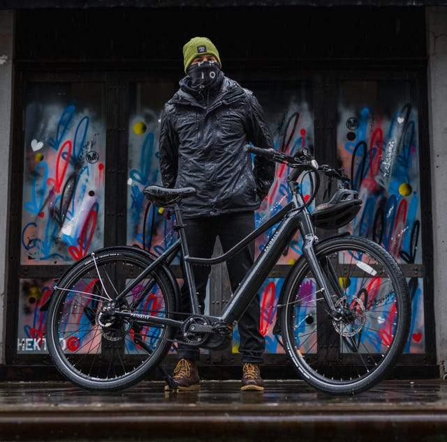 man standing behind priority current e bike