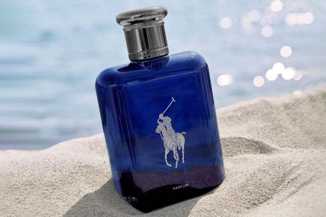 ralph lauren polo blue bottle in sand by the ocean
