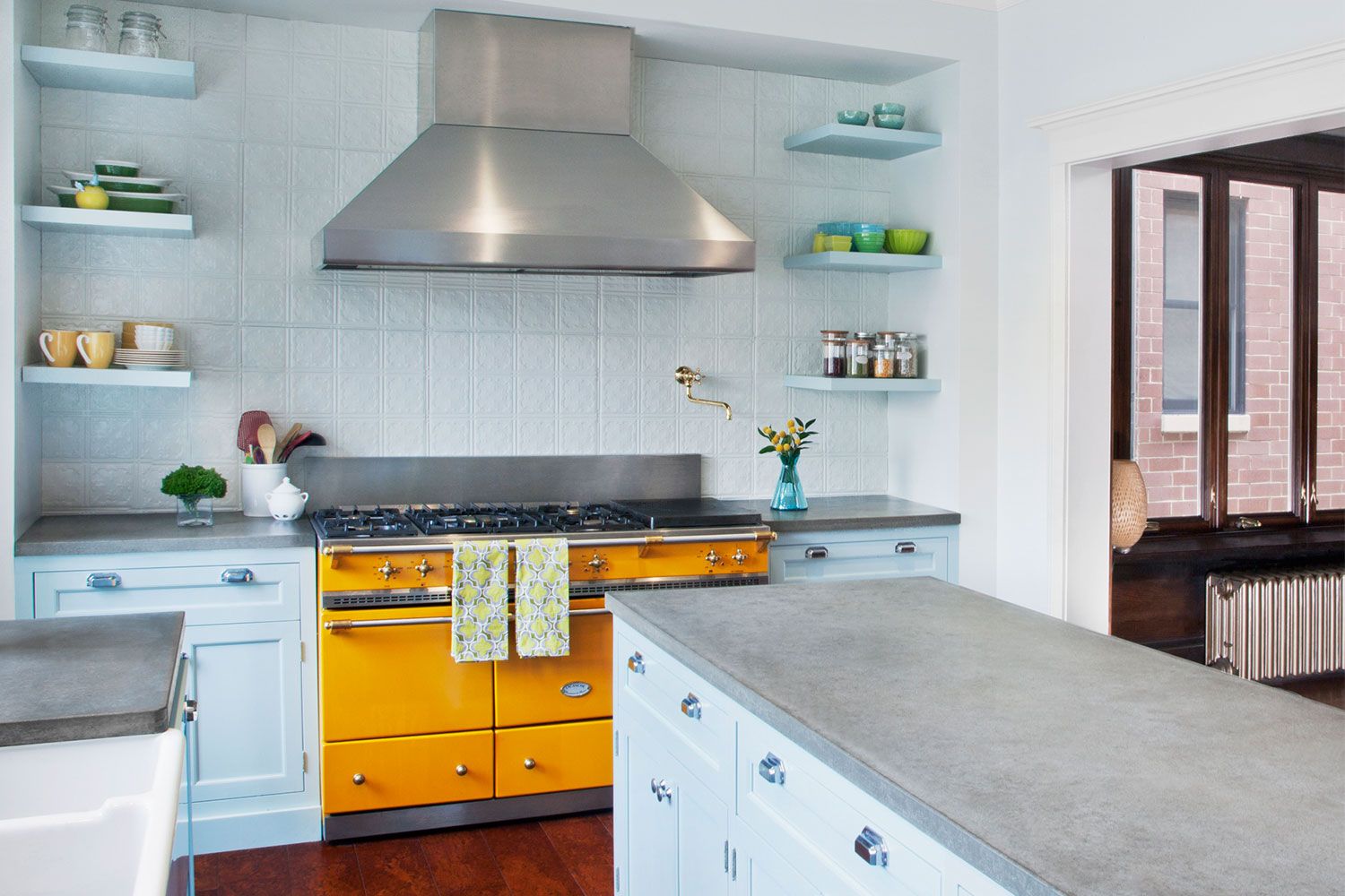 Kitchen With Yellow Accents - 11 Trendy Ideas That Bring Gray And Yellow To The Kitchen : Yellow kitchen with tiled flooring and a glazed window overlooking the serene outdoor view.