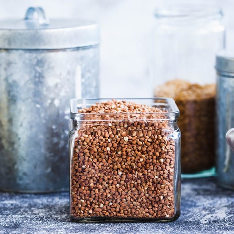 Raw Buckwheat In Glass Jar In a Composition Of Various Containers