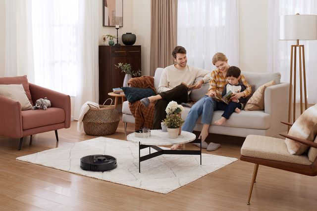 family in living room with black roborock